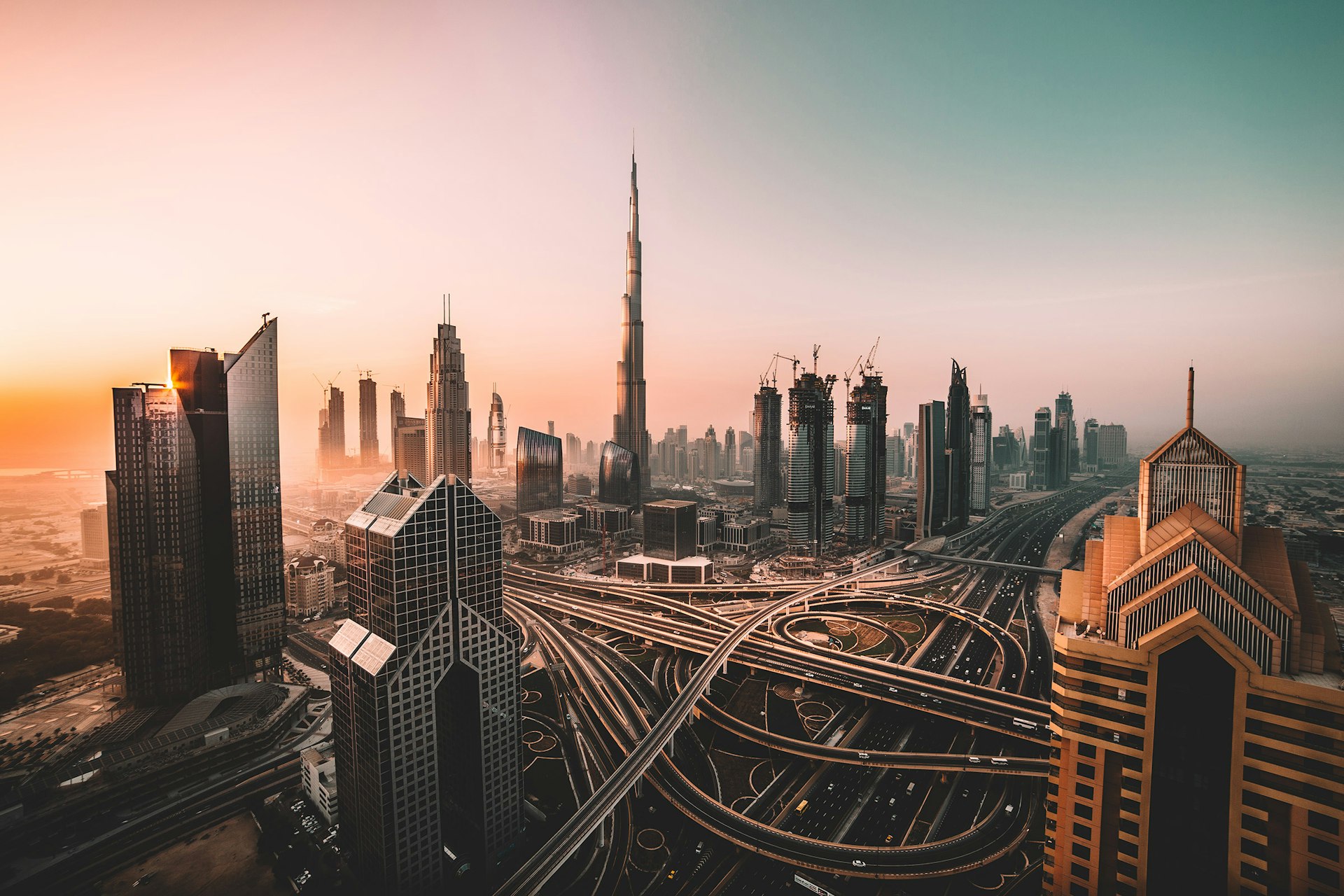 Construction cranes and towers in a growing skyline